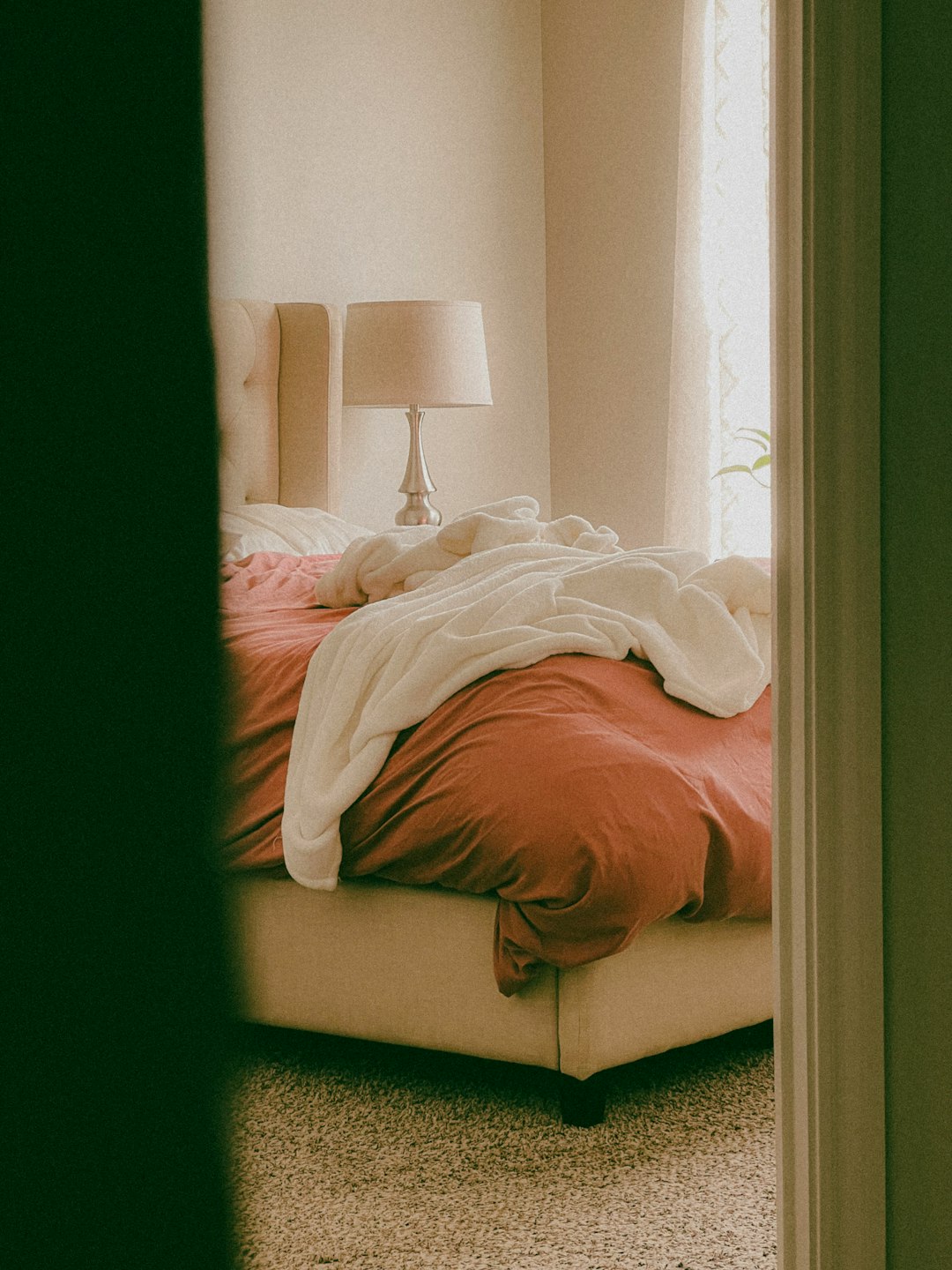 a-bed-sitting-in-a-bedroom-next-to-a-window-dsb0gisofog